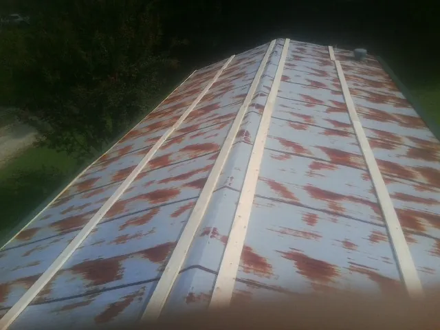 Rusted metal roof panels with new wood purlins before replacement — Storm Damage Roof Repair in Pendleton by Roofing Brothers